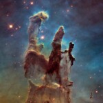 The Eagle Nebula, as captured by the Hubble Telescope. NASA assigned colors to different elements: blue for oxygen, red for sulfur, and green for nitrogen and hydrogen. The image also makes ultraviolet light visible.