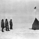 Roald Amundson and his expedition plant the Norwegian flag at the South Pole in 1911.