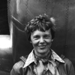 One of the last photographs of Amelia Earhart, standing with the plane she would attempt to fly around the world in 1937.